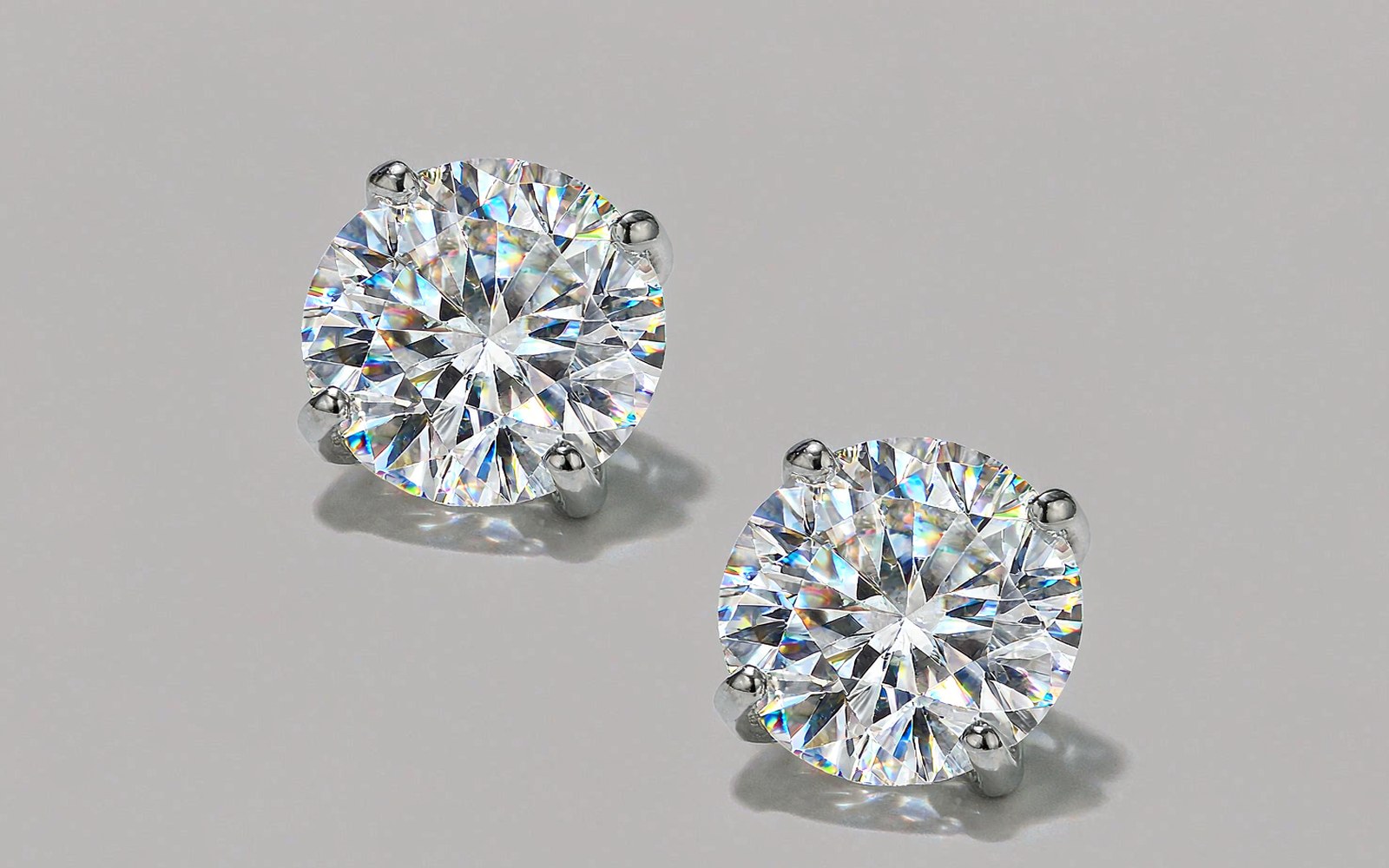 Pair of moissanite stud earrings on a light background