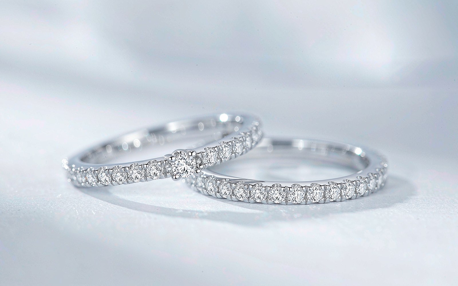 White gold moissanite ring set on a bright studio background