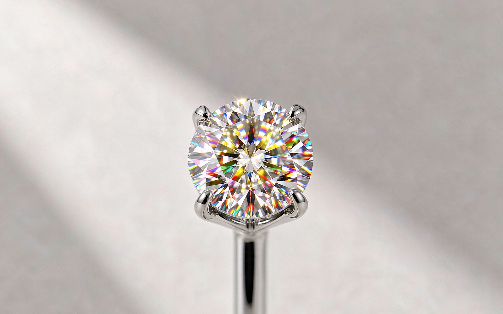 Loose round moissanite gemstone sparkling on a light background